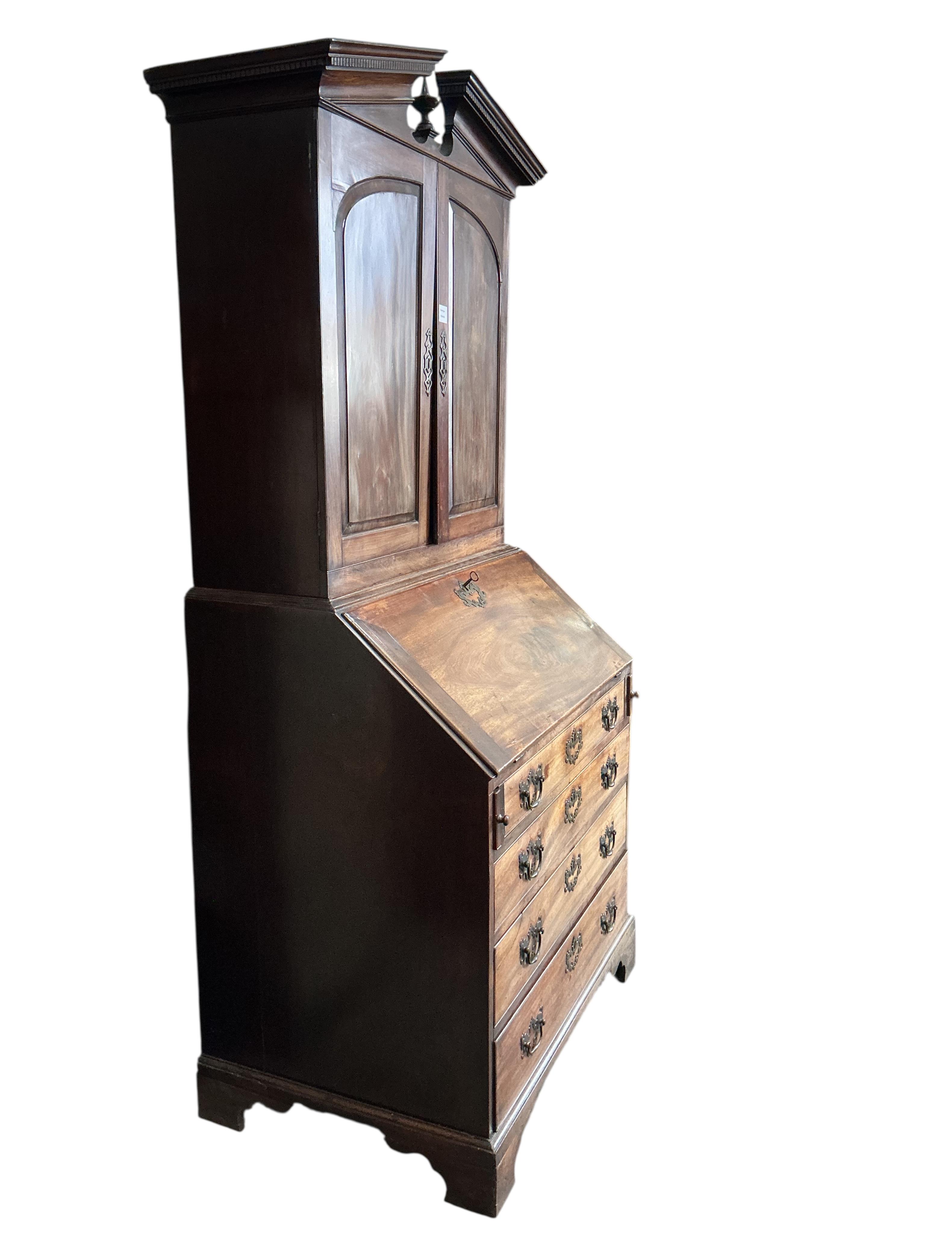A small George III mahogany bureau cabinet with broken arch pediment, width 95cm, depth 62cm, height 198cm